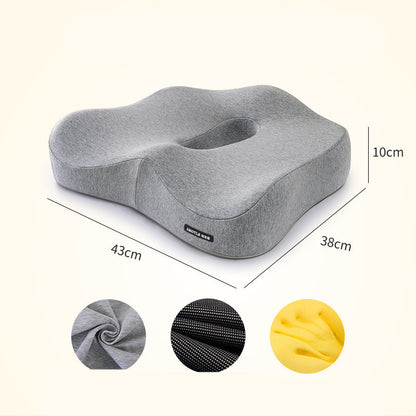 The Healthy Lumbar Support Cushion by Aloha Relax, measuring 43cm by 38cm by 10cm, promises stress relief and sleep improvement. The ergonomically designed seat cushion comes in gray with three fabric texture samples showcased in circular insets at the bottom, available in gray, black, and yellow colors.