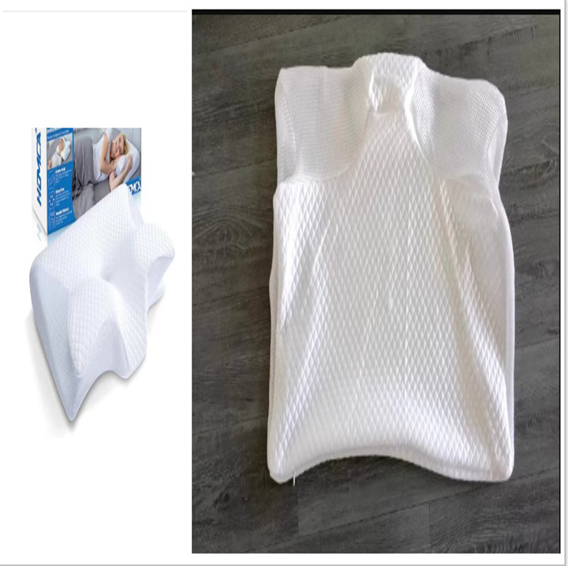 The image displays two views of the Aloha Relax Neck Memory Home Sleep Pillow. On the left, it is shown in its packaging, and on the right, it is unwrapped and placed on a gray wood floor. This white pillow features a textured surface engineered for comfort and support.