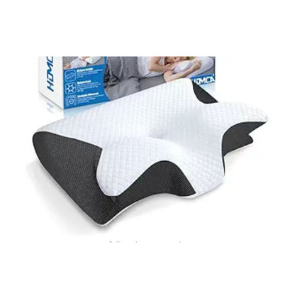 Introducing the Neck Memory Home Sleep Pillow by Aloha Relax, an ergonomically designed pillow with a contoured memory foam structure in a sleek black and white color scheme, ideal for complementing any bedding ensemble. The background showcases packaging that features text along with an image of someone sleeping contentedly.