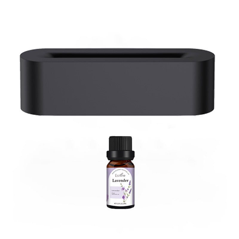 A rectangular black Aloha Relax Flame Aroma Diffuser Air Humidifier stands above a small brown bottle labeled "Lavender," featuring a black cap and a white label with purple and green graphics. This diffuser, equipped with ultrasonic humidification, enhances the ambiance against a white backdrop by offering 7 colors of soothing light.