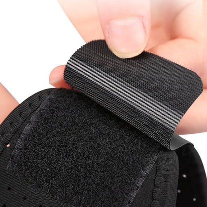 A hand adjusts the black Velcro strap of Aloha Relax's Adjustable Chin Strap to Reduce Snoring. The ergonomic sleep aid features a hook and loop fastening with a striped design, as the hand prepares to attach the loop section for optimal snoring reduction.
