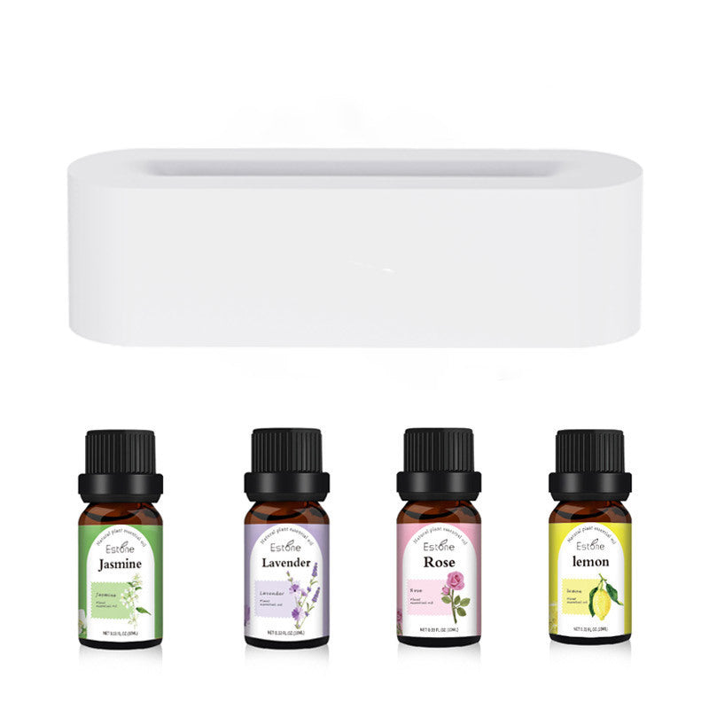 A four-pack of Jasmine, Lavender, Rose, and Lemon essential oils sits beneath the Aloha Relax Flame Aroma Diffuser Air Humidifier. This ultrasonic cool mist maker displays charming plant illustrations on each bottle and offers a soothing ambiance with 7 LED colors.