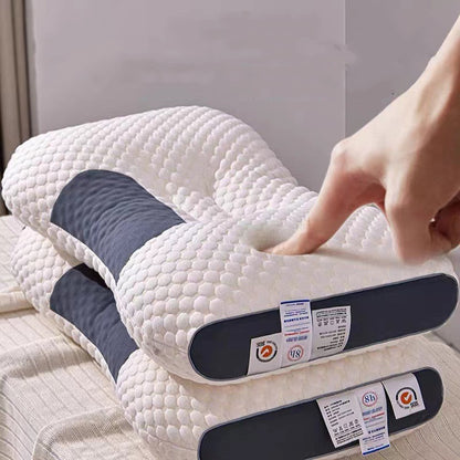 A person presses a finger into the surface of a white, textured 3D Knitted Cotton Pillow Sleep Aid with navy blue sides. The pillow's tags are visible, showing various information and care instructions. Two other similar pillows from the Aloha Relax collection are stacked underneath, promoting sleep improvement and stress relief.