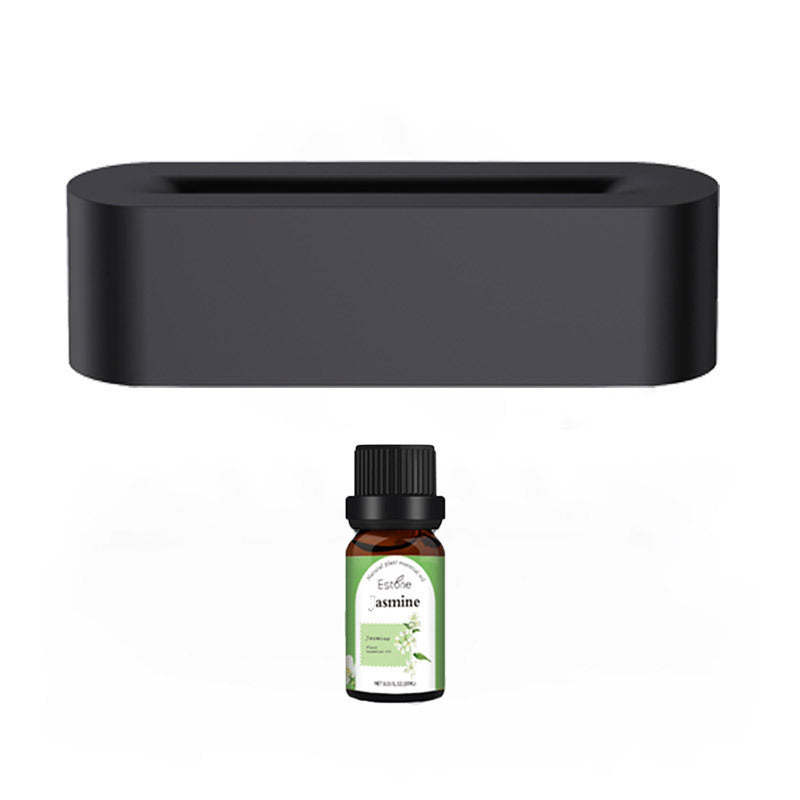 A black rectangular Aloha Relax Flame Aroma Diffuser Air Humidifier, equipped with ultrasonic cool mist technology, is placed above a small bottle labeled "Jasmine." The green and white label showcases jasmine flowers, while the diffuser provides 7 colors of ambiance to enrich your sensory experience.